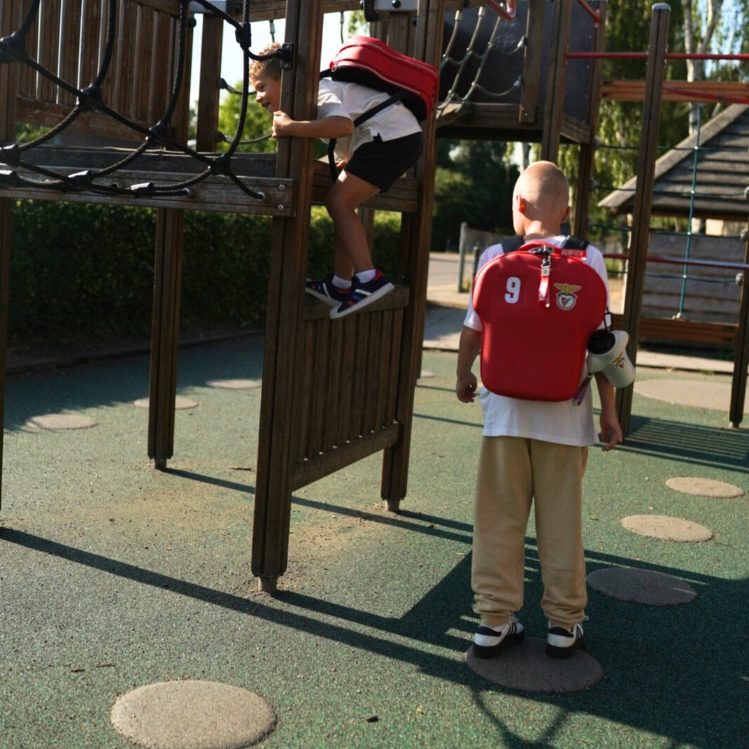 boys on a playground wearing Benfica backpack size large